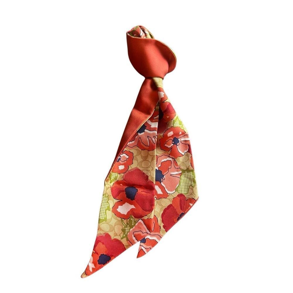 COACH silk twilly scarf orange poppy and tan signature Cs background